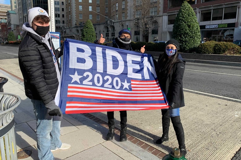 Balian Sanders, Yessica Leon, and Bryan Godinez hold a Biden 2020 flag.