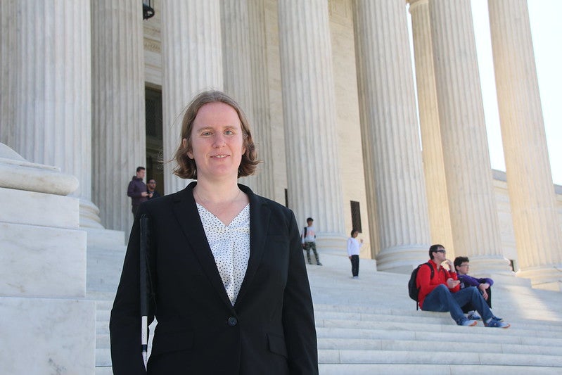Karla Gilbride standing on the steps of the Supreme Court after arguing Morgan v. Sundance.