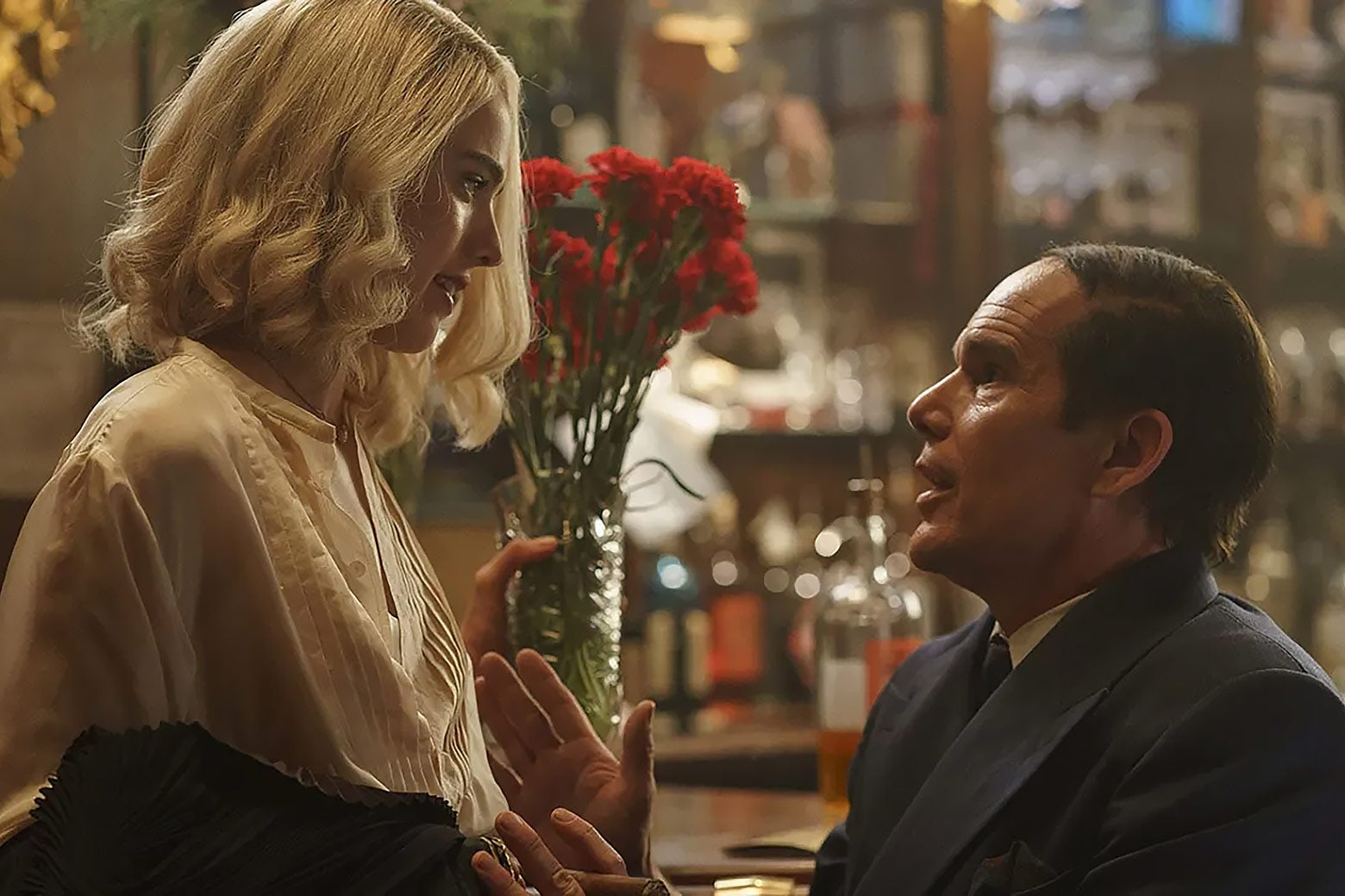 A short-haired middle-aged white man looking up adoringly at a much younger, college-aged woman.