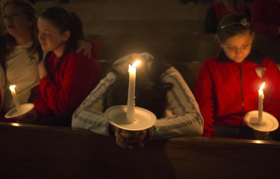 A woman mourns during a candlelight church service at St Mary's for victims of a fertilizer plant explosion in the town of West, near Waco, Texas April 18, 2013. 