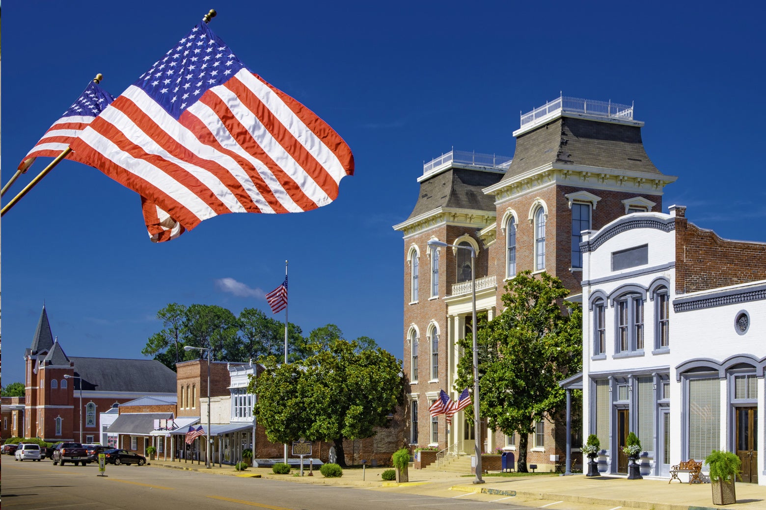 A typical small-town Main Street with an American flag flying front and center. 