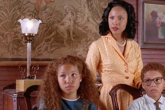 Young Journee and Jake Smollett sit at a table with Lynn Whitfield standing behind them.