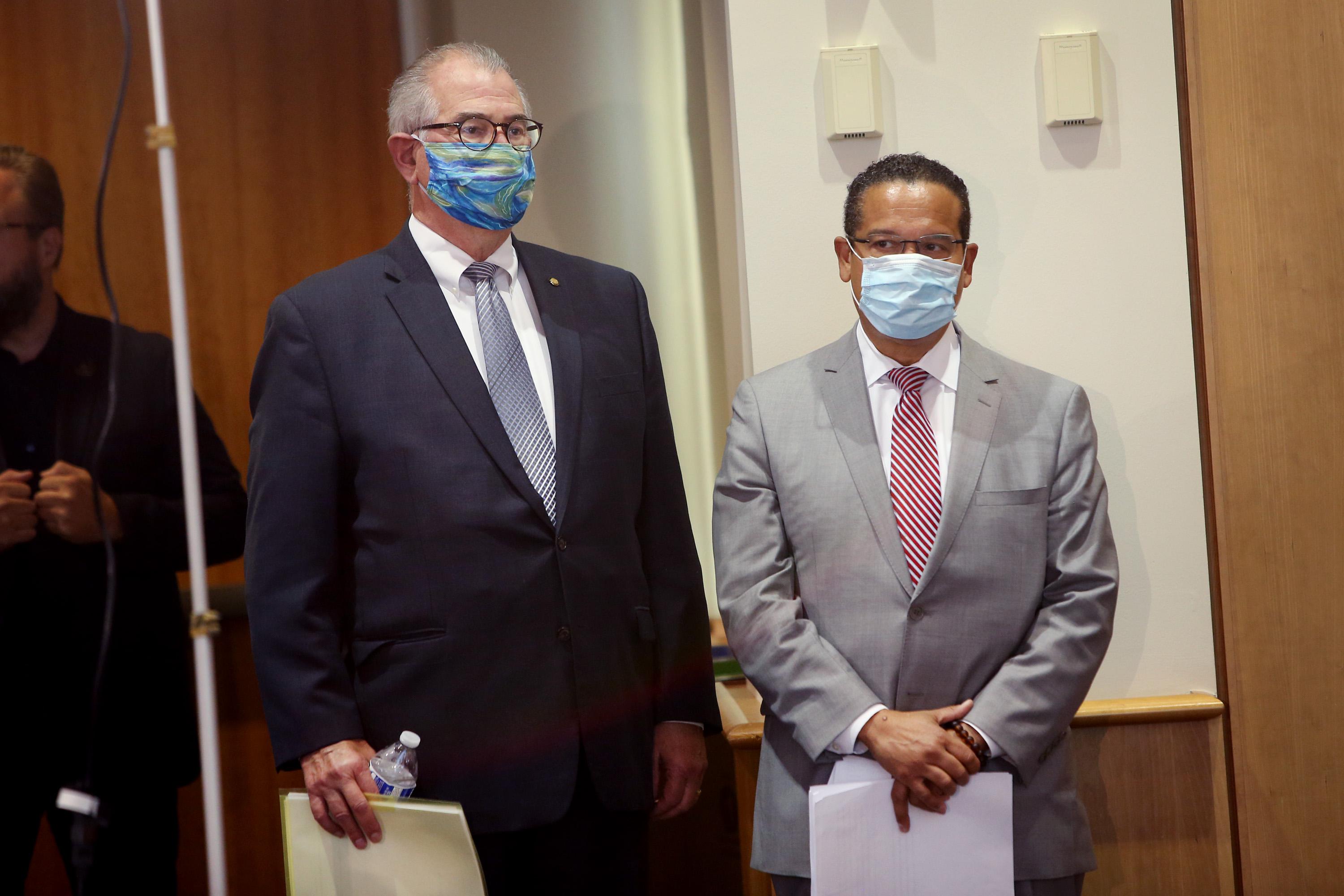 Mike Freeman and Keith Ellison stand next to each other wearing face masks.