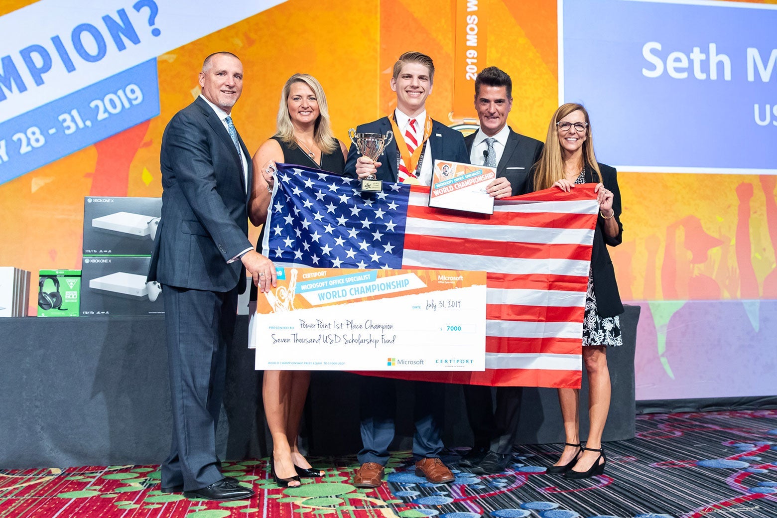 Maddox and others hold up an American flag and his prize check.