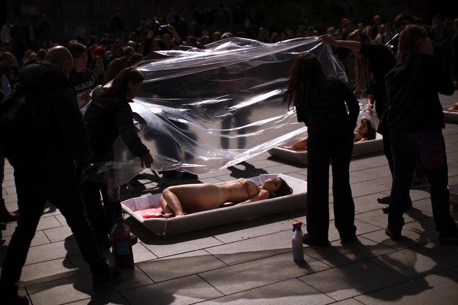 Animal rights activist from the group 'Animal Equality' are covered with plastic sheets to represent meat packaging as they stage a protest during "Day Without Meat" event in Barcelona, Spain on March 20, 2013.