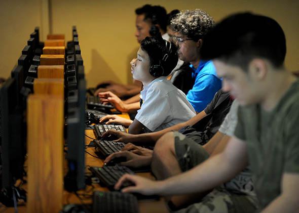 Filipino youths gather at an Internet cafe in Manila on February 18, 2014. 