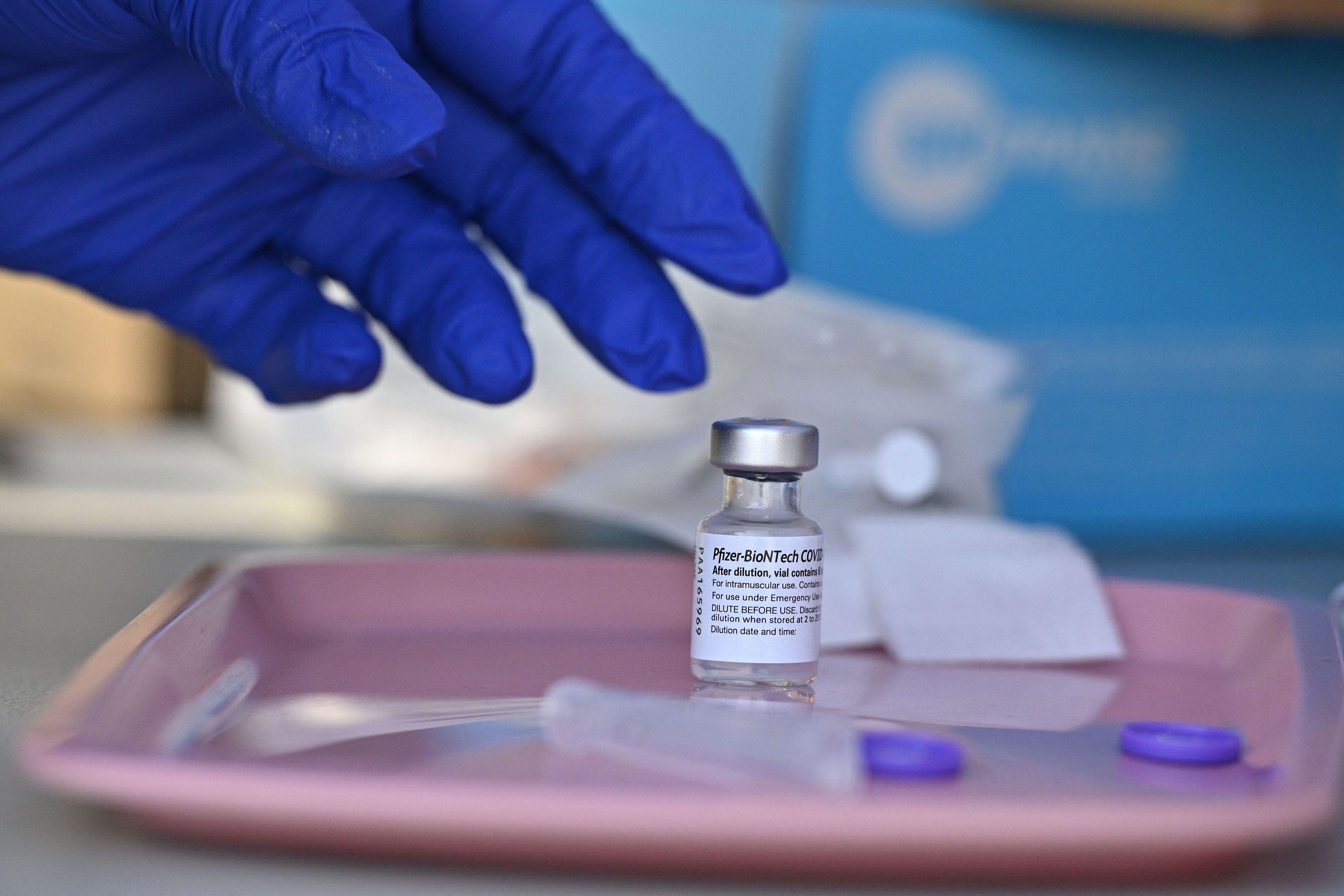 A nurse reaches for a vial of Pfizer-BioNTech Covid-19 vaccine at a pop up vaccine clinic in the Arleta neighborhood of Los Angeles, California, August 23, 2021. Around 52 percent of the American population is fully vaccinated, but health authorities have hit a wall of vaccine hesitant people, impeding the national campaign. (Photo by Robyn Beck / AFP) (Photo by ROBYN BECK/AFP via Getty Images)