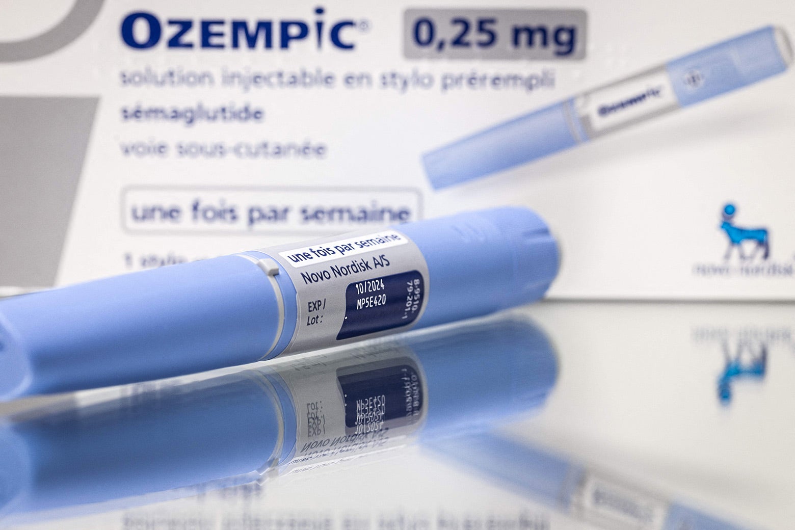 A box of the diabetes medication Ozempic, with a syringe lying next to it.