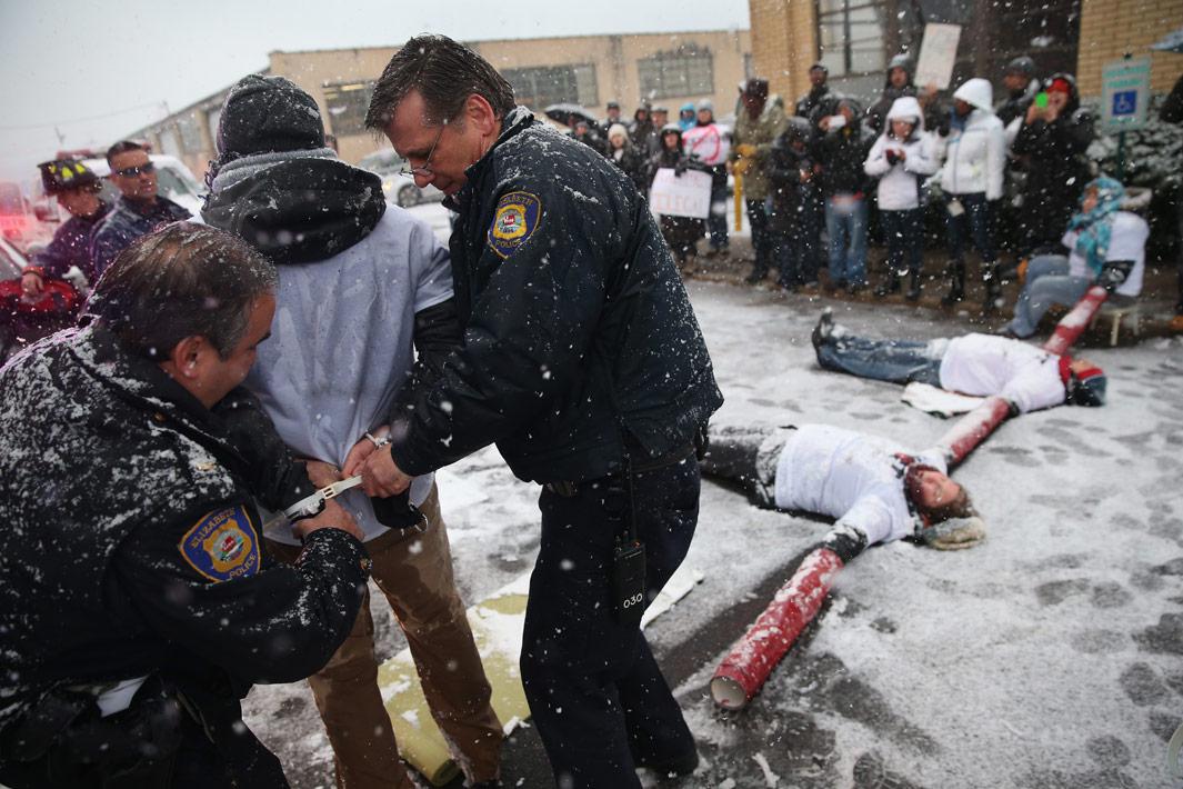 Elizabeth, N.J. Police arrest protesters blocking the entrance of an immigrant detention center on December 10, 2013 in Elizabeth, N.j.. A coalition of immigrant advocacy groups marked international Human Rights Day, staging the civil disobedience action at the Elizabeth Detention Center, and eight protesters were arrested. The event was designed to draw attention to the continued mass deportations of undocumented immigrants by the U.S. Immigration and Customs Enforcement (ICE), as well as Congress' inability to pass immigration reform. The Obama administration is on track to have removed 2 million immigrants from the United States, the most of any presidential administration.  