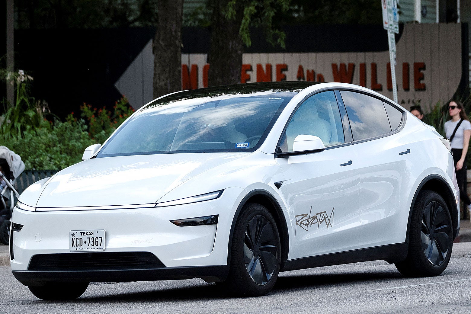 A Tesla robotaxi drives on the street along South Congress Avenue in Austin, Texas.