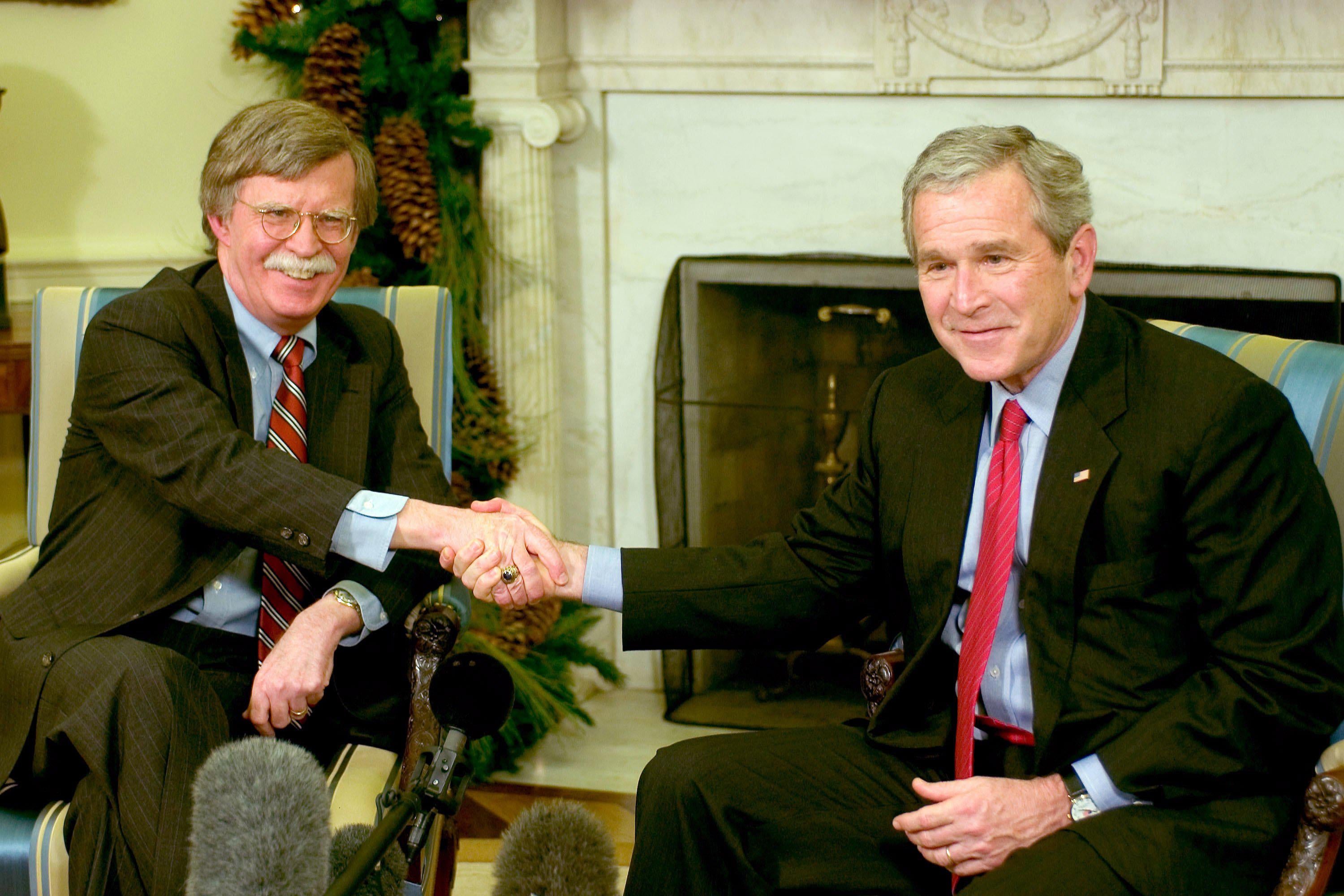 WASHINGTON - DECEMBER 4:  (AFP OUT) US President George W. Bush (R) and Ambassador to the UN John Bolton (L) meet in the Oval Office of the White House December 4, 2006 in Washington, DC. Bush accepted Bolton's resignation as Ambassador to the United Nations when his term is up in January 2007.  (Photo by Ron Sachs-Pool/Getty Images)