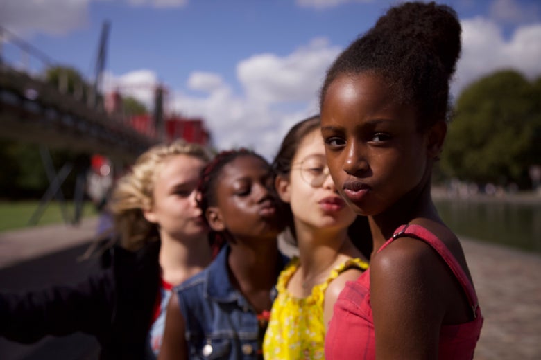 Four young women face the camera, their lips pursed in a kiss.
