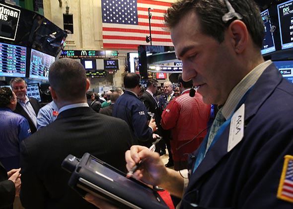 Traders work on the floor of the New York Stock Exchange after the ringing the Opening Bell on April 1, 2014 in New York City.
