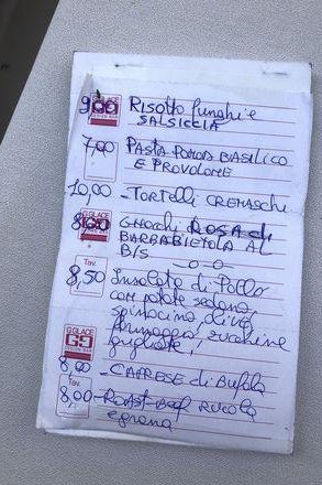 A list of ingredients, handwritten on a piece of note paper.
