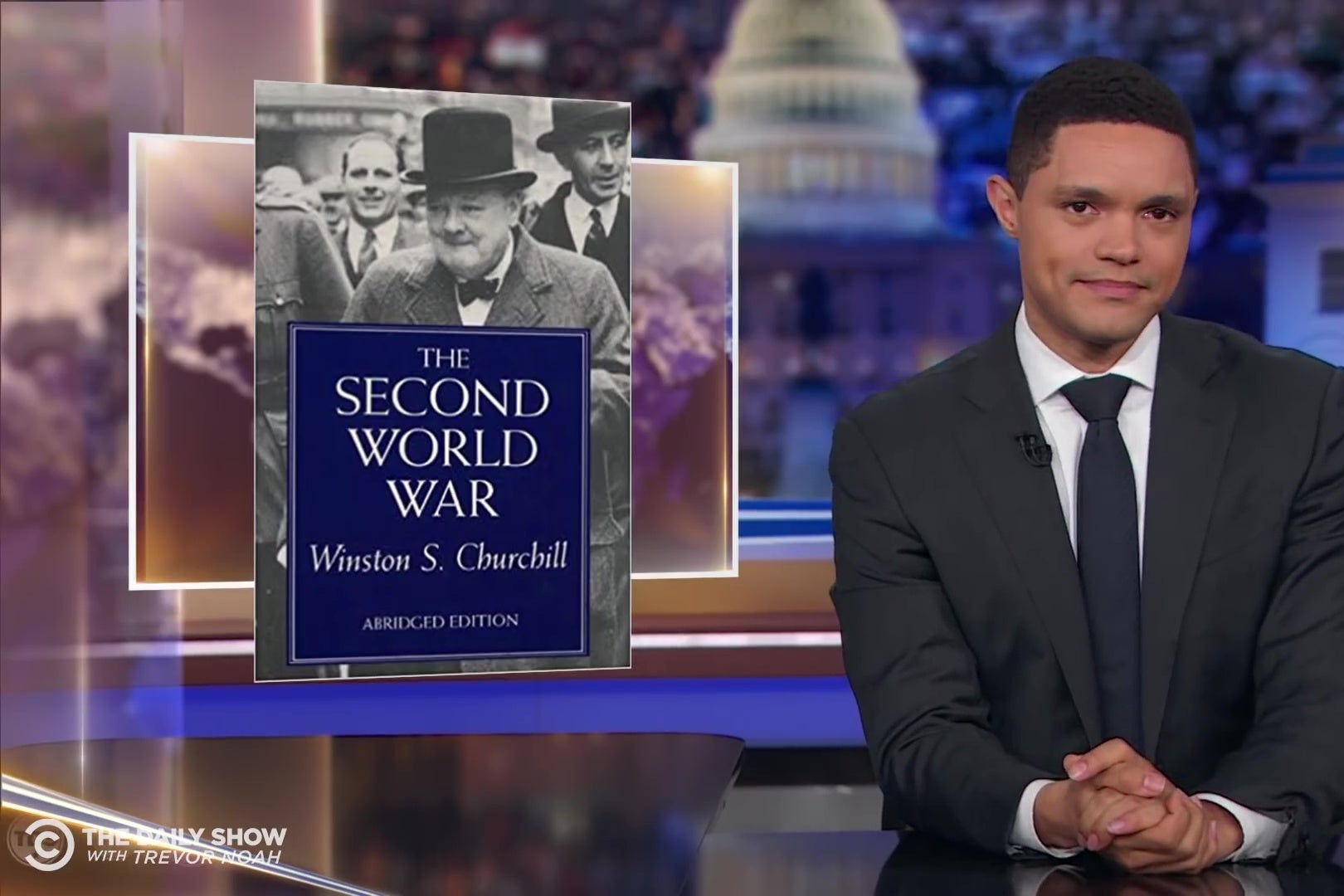 Trevor Noah looks skeptical in front of a picture of The Second World War.