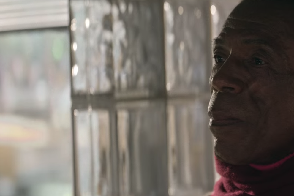 André De Shields stands and looks off camera.