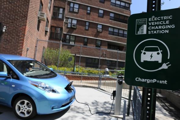 An electric car charges at a station.