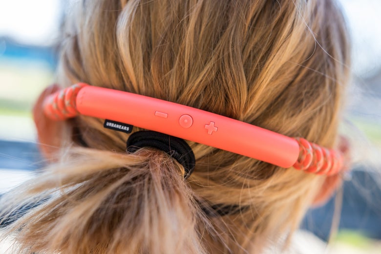 Back of runner's head wearing Urbanears Stadion headphones.
