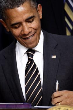 U.S. President Barack Obama signs