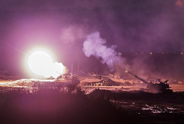 An Israeli artillery gun fires a 155mm shell towards targets in the Gaza Strip from their position near Israel's border with the Gaza Strip.