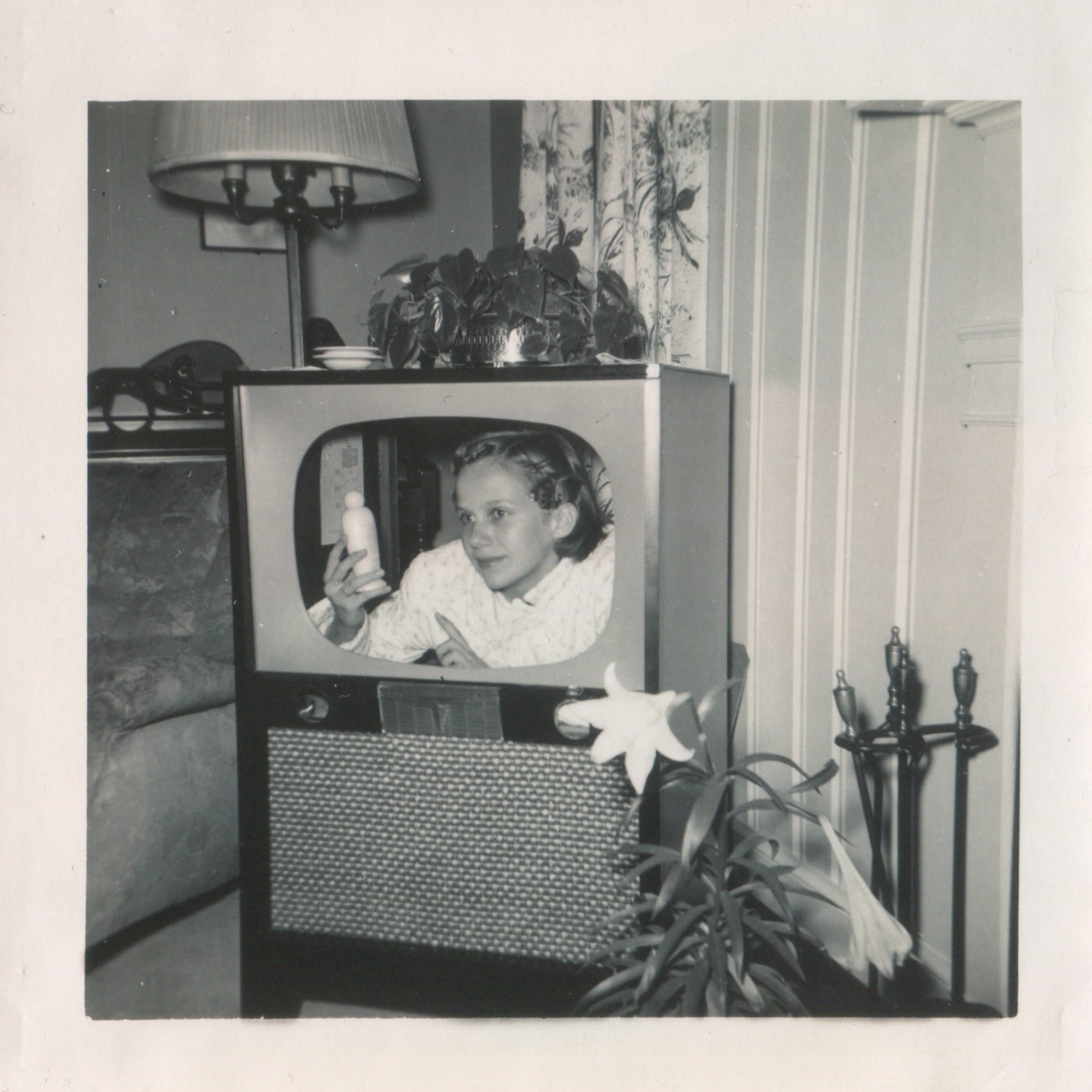 A woman poses inside her TV set.