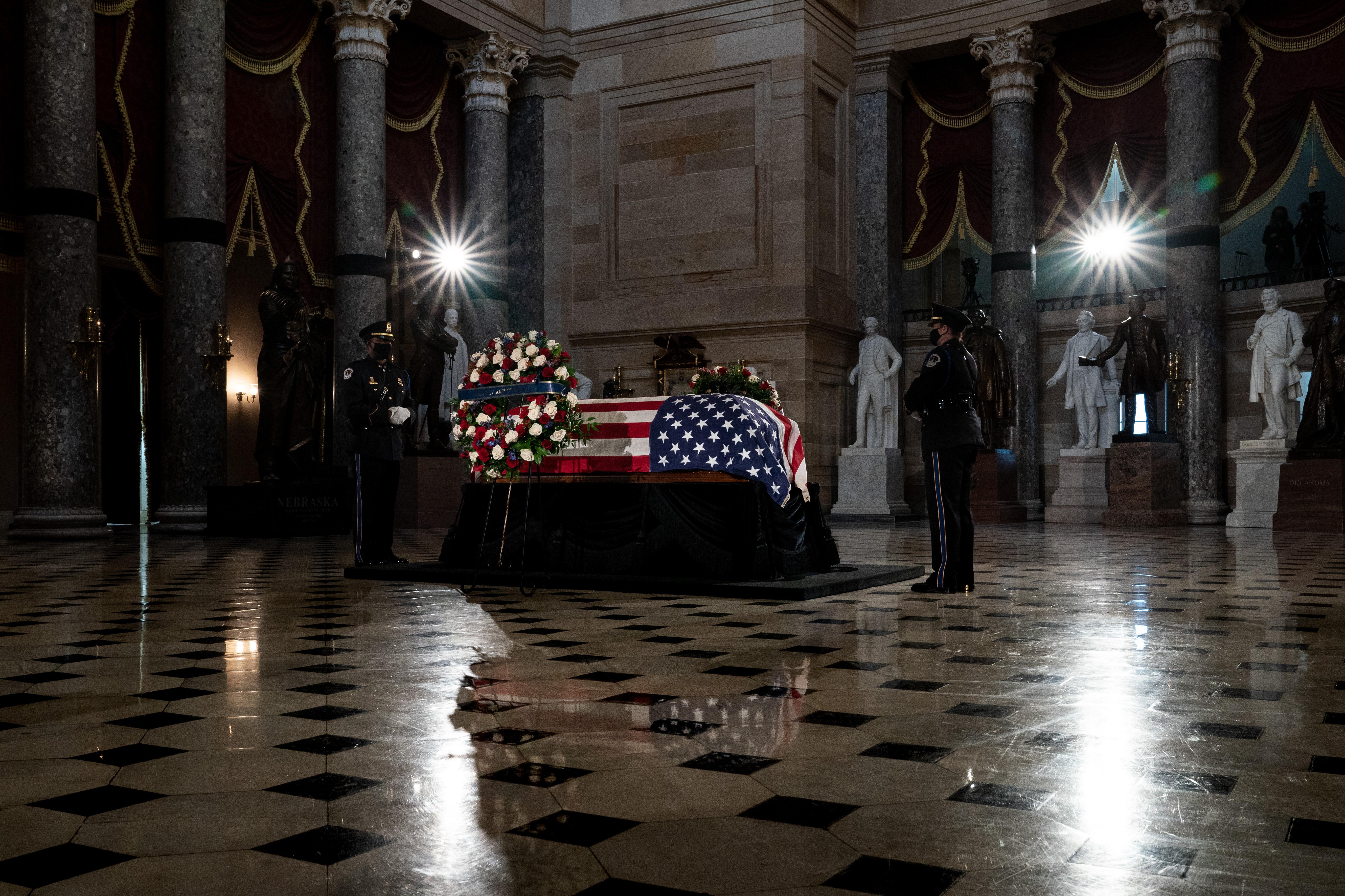 The flag-draped casket of the late Associate Justice Ruth Bader Ginsburg lies in state in Statuary Hall of the US Capitol.