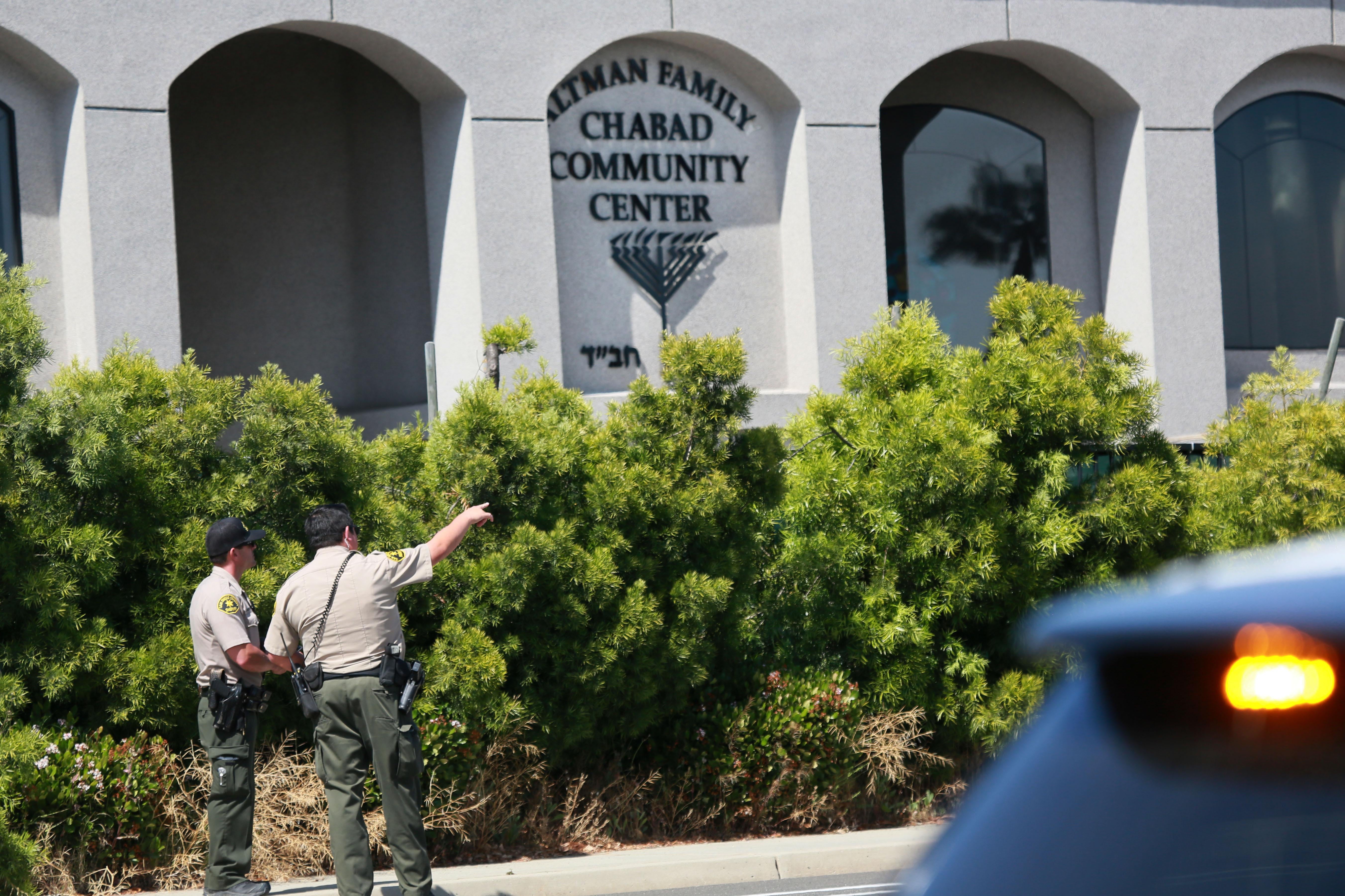 San Diego Sheriff deputies look over the Chabad of Poway Synagogue after a shooting on Saturday, April 27, 2019 in Poway, California. - A gunman opened fire at a synagogue in California, killing one person and injuring three others including the rabbi as worshippers marked the final day of Passover, officials said Saturday, April 27, 2019. The shooting in the town of Poway came exactly six months after a white supremacist shot dead 11 people at Pittsburgh's Tree of Life synagogue -- the deadliest attack on the Jewish community in the history of the United States. (Photo by SANDY HUFFAKER / AFP)        (Photo credit should read SANDY HUFFAKER/AFP/Getty Images)