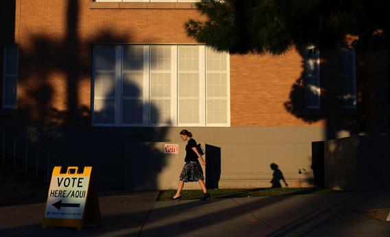 A woman walks outside Kenilworth School as she prepares to vote during the U.S. presidential election in Phoenix, Arizona November 6, 2012.