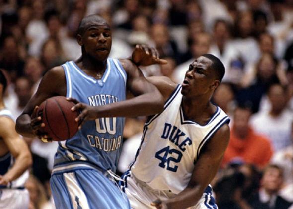 Elton Brand #42 of the Duke Blue Devils tries to guard Brendan Haywood #00 of the North Carolina Tar Heels.