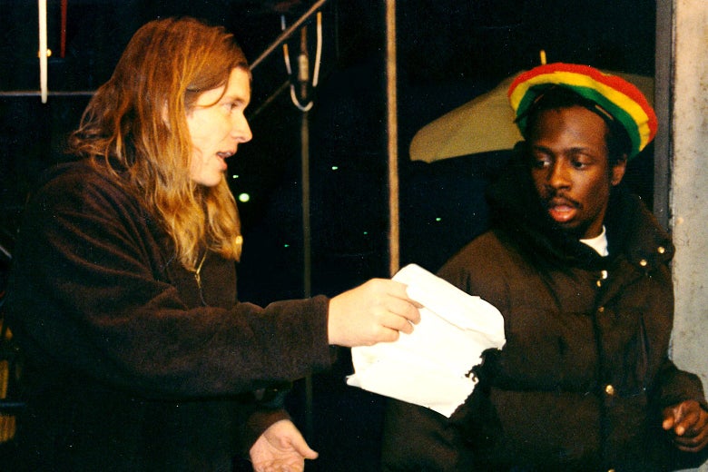 Mark Woollen chats with Wyclef Jean on the set of "Rumble In the Jungle."