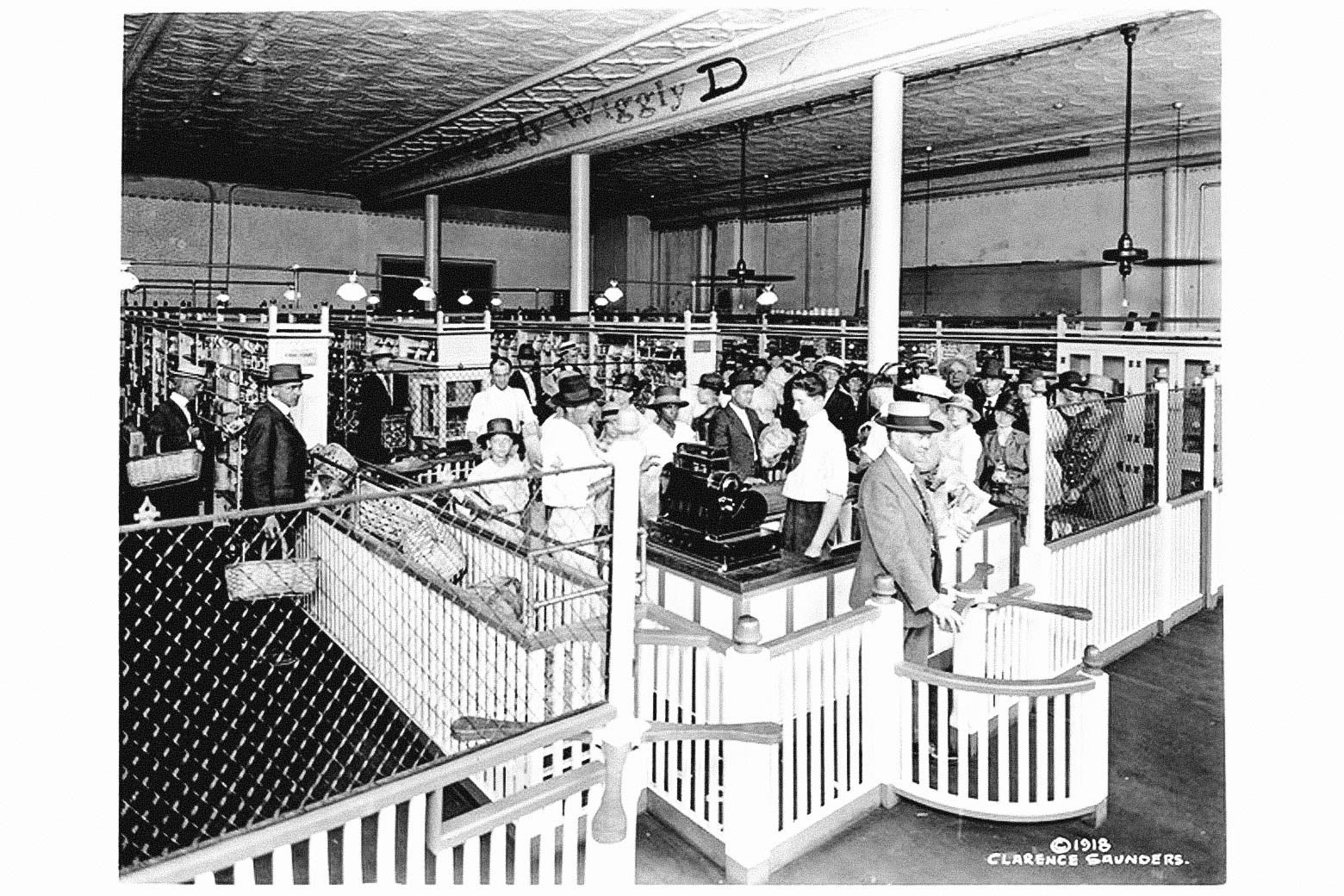 Black-and-white photo of shoppers waiting in line to check out