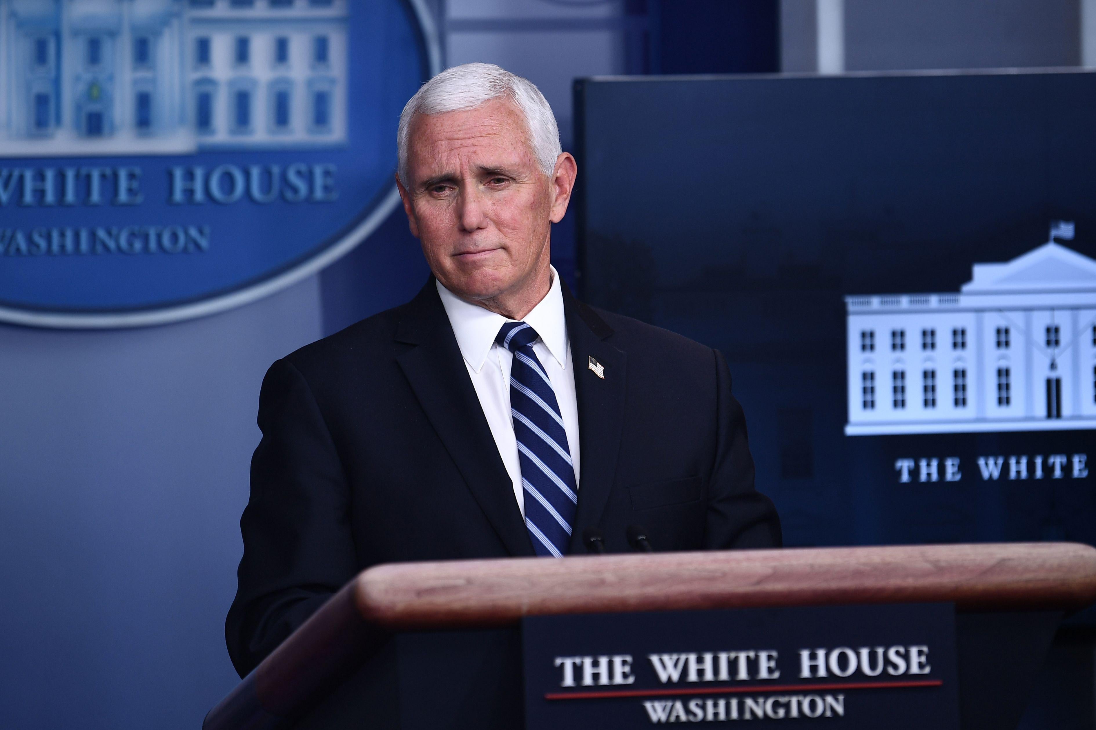 Mike Pence standing at a podium in the White House press briefing room