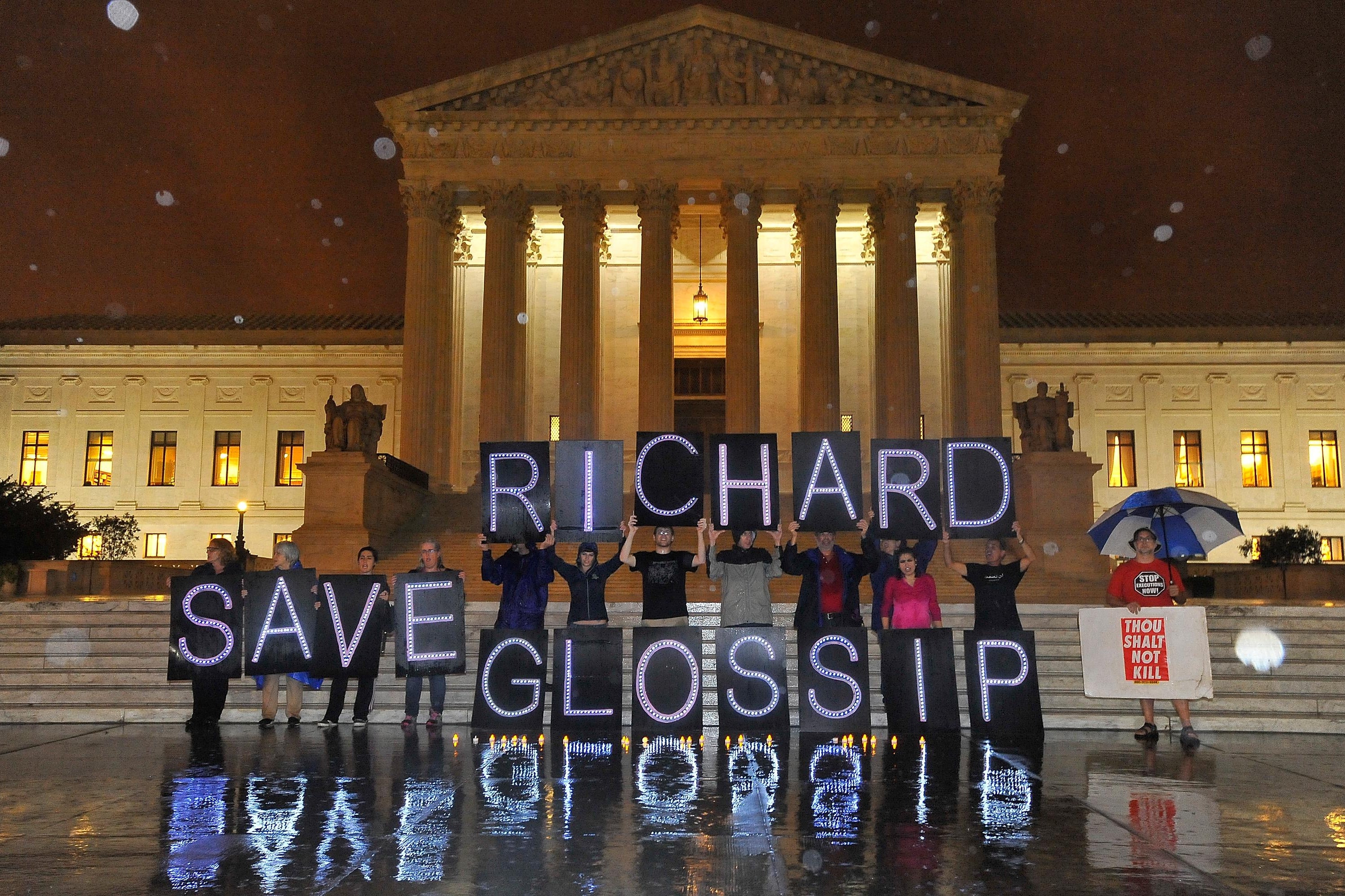 People hold up signs in front of the Supreme Court that say Save Richard Glossip.