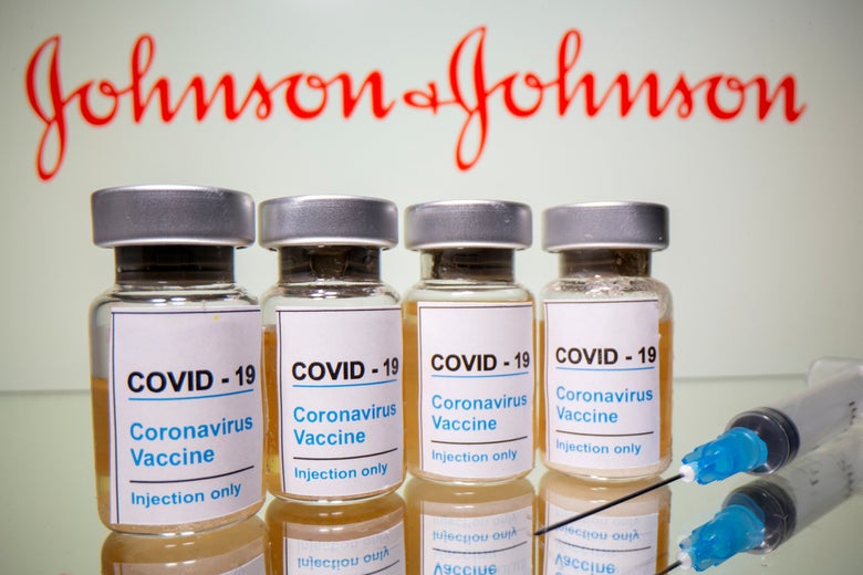 A syringe and vials labeled "COVID-19 Coronavirus Vaccine Injection Only" in front of the Johnson & Johnson logo