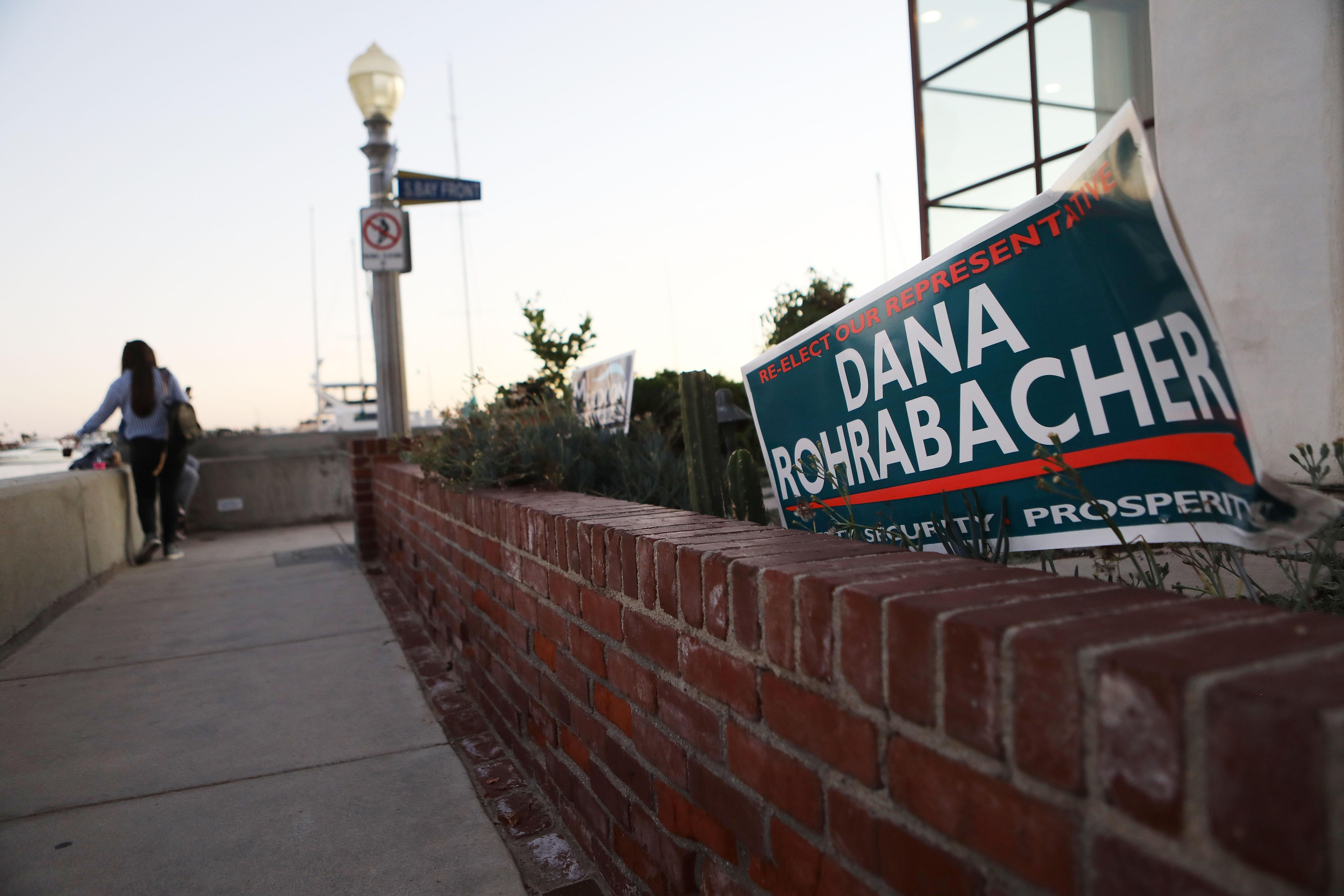A Dana Rohrabacher campaign sign is posted in front of a home.