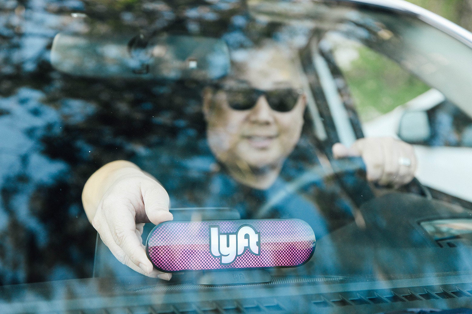 A Lyft driver places the Amp on his dashboard on January 31, 2017 in San Francisco, California.