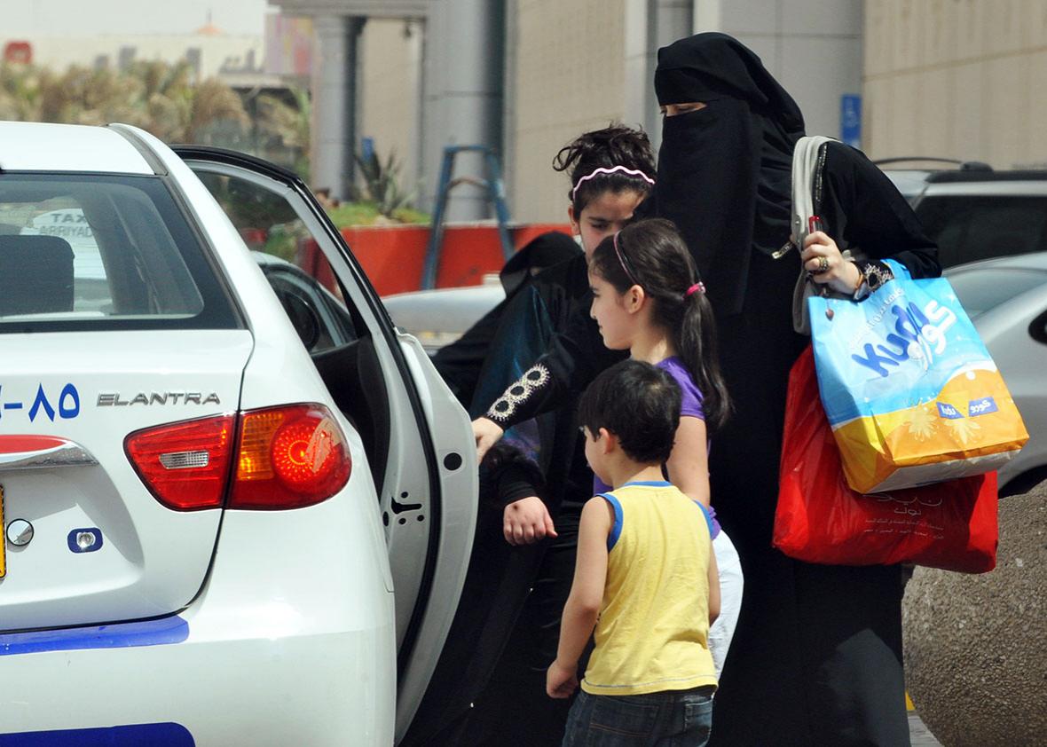 A Saudi woman and her children get into a taxi in Riyadh on June 14, 2011, three days before a June 17 nationwide campaign by Saudi women who are planning to take the wheel in protest against a driving ban which is unique to the kingdom that applies a strict version of Sunni Islam.  