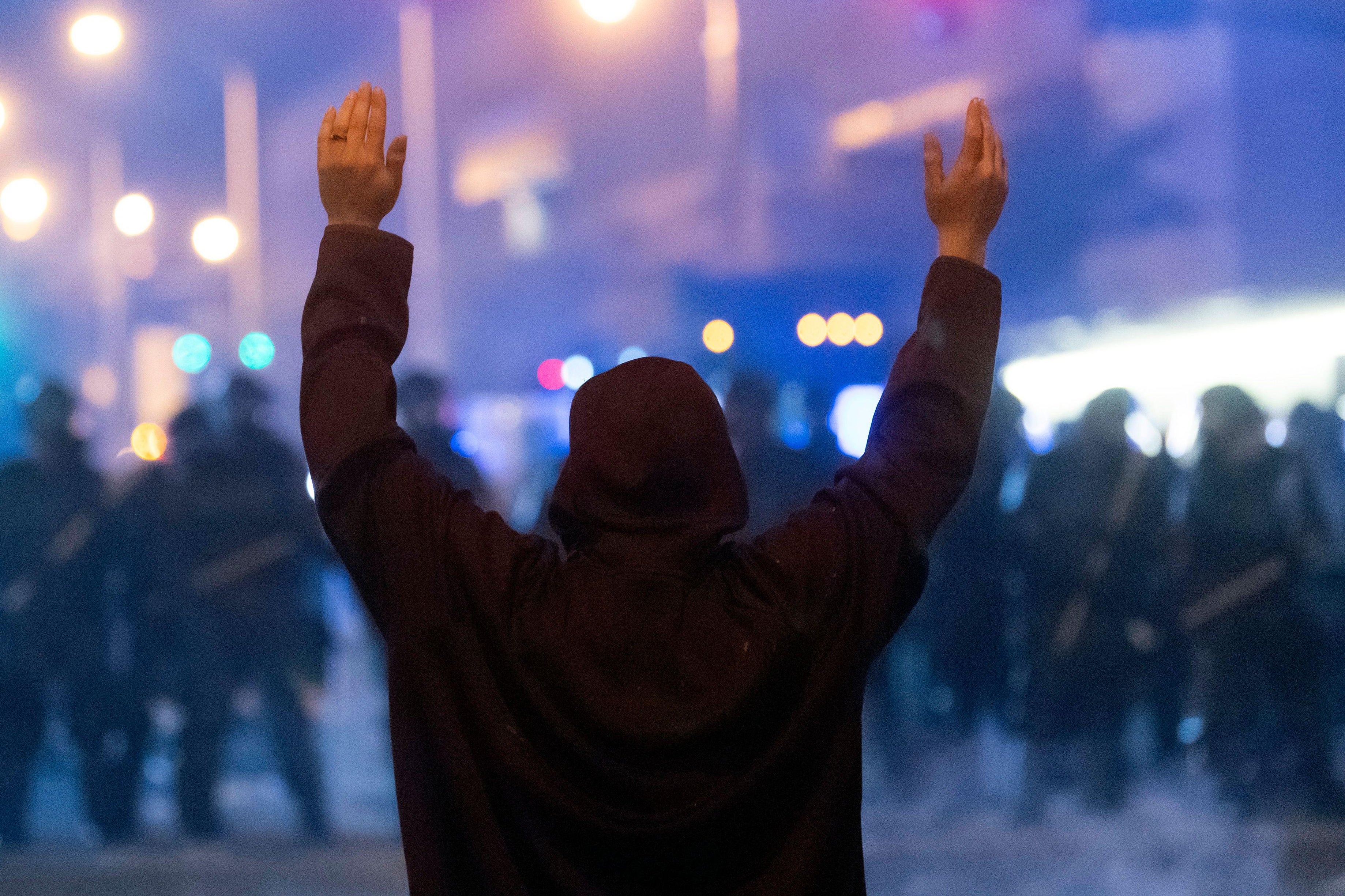 A protester faces off with police during rioting and protests in Atlanta on May 29, 2020. 
