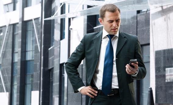 Young businessman with smartphone.