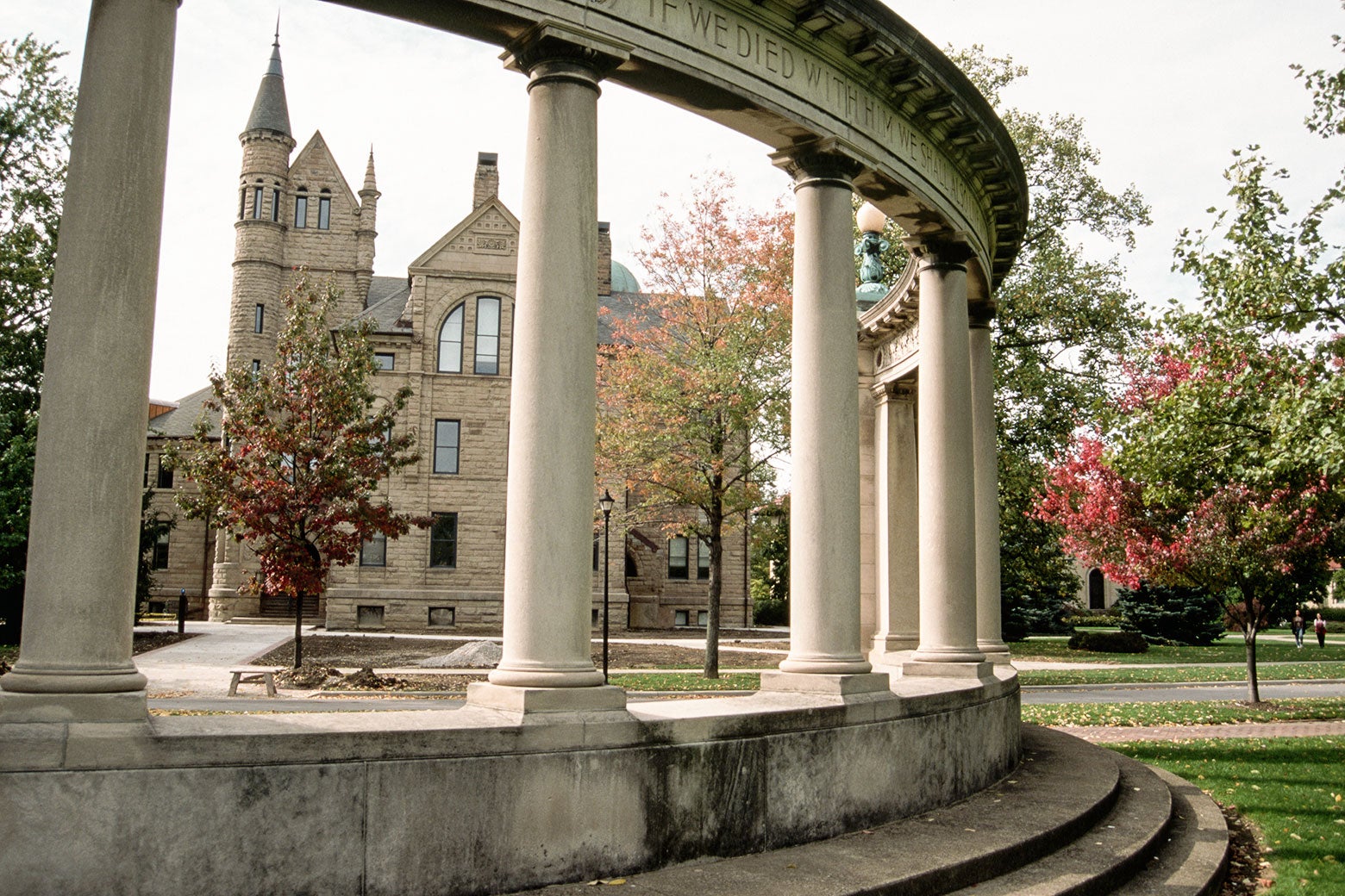 A colonnade in front of a historic building on a college campus.