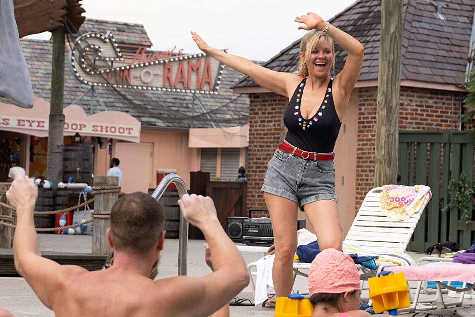 Kirsten Dunst, as Krystal Stubbs, dances by a pool at the water park in the show.