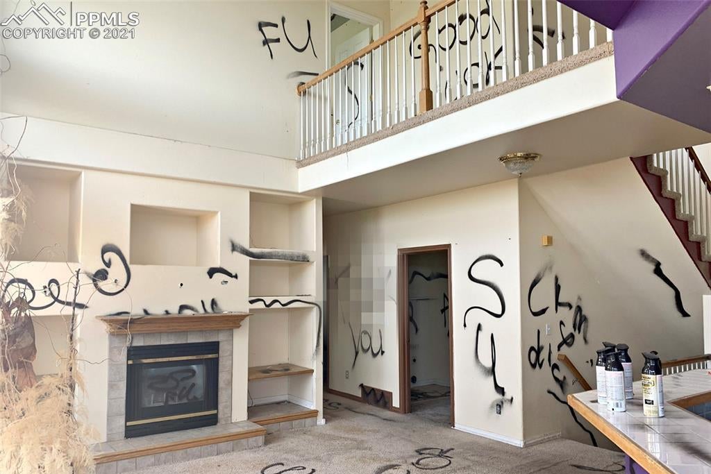 A living room covered in spray-painted obscenities.