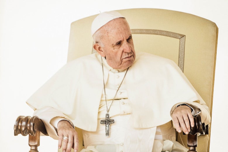 Pope Francis sits in an ornate chair.
