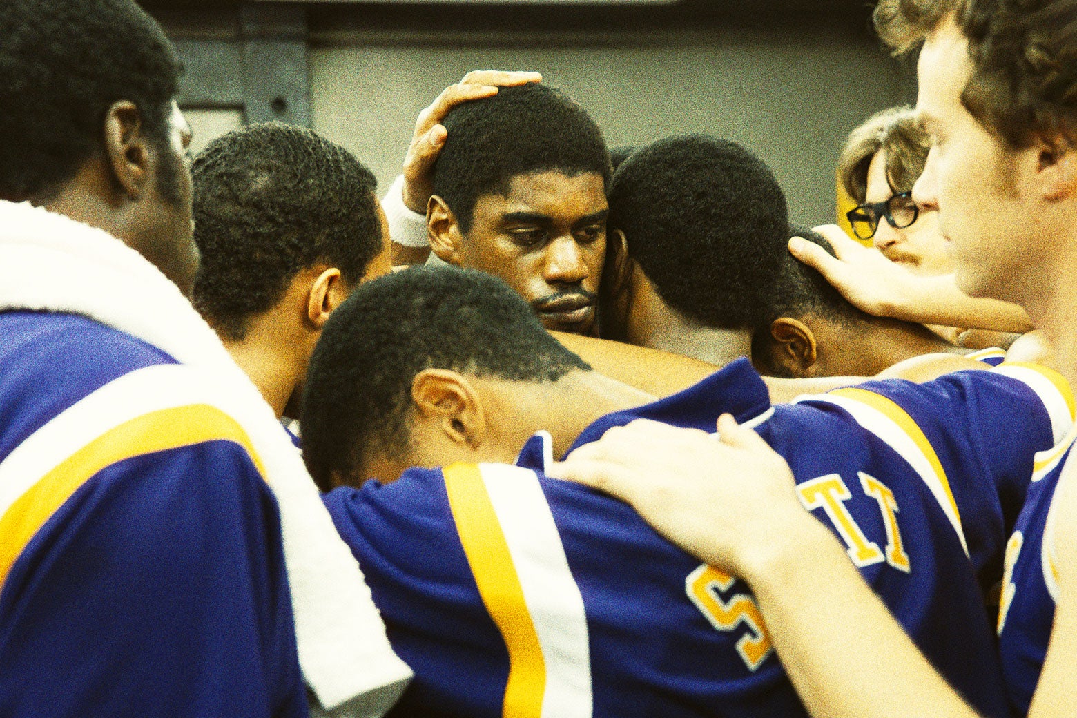 L.A. Lakers in a group hug, with a tearful Magic Johnson in the center.