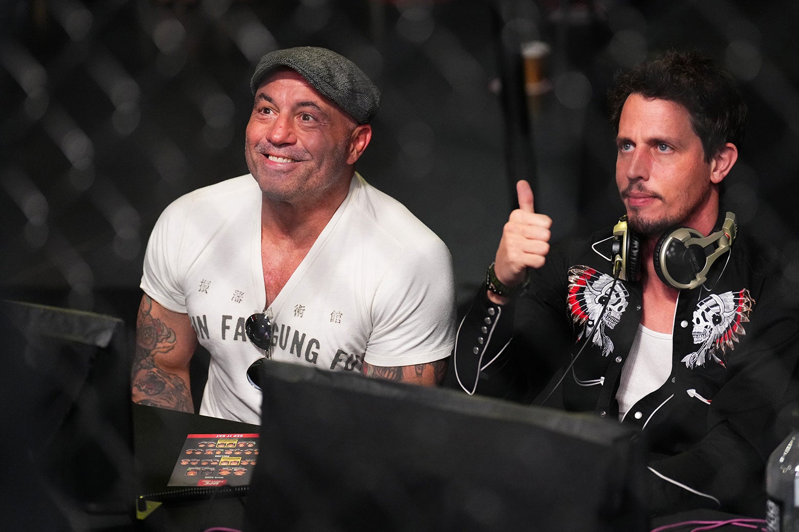 The two comedians are seated in the audience; Hinchcliffe is giving a thumbs-up for the photo.