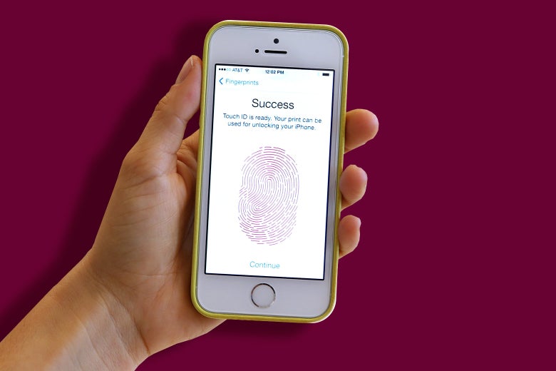 A hand holding an iPhone. The screen shows that the user has just set up Touch ID.