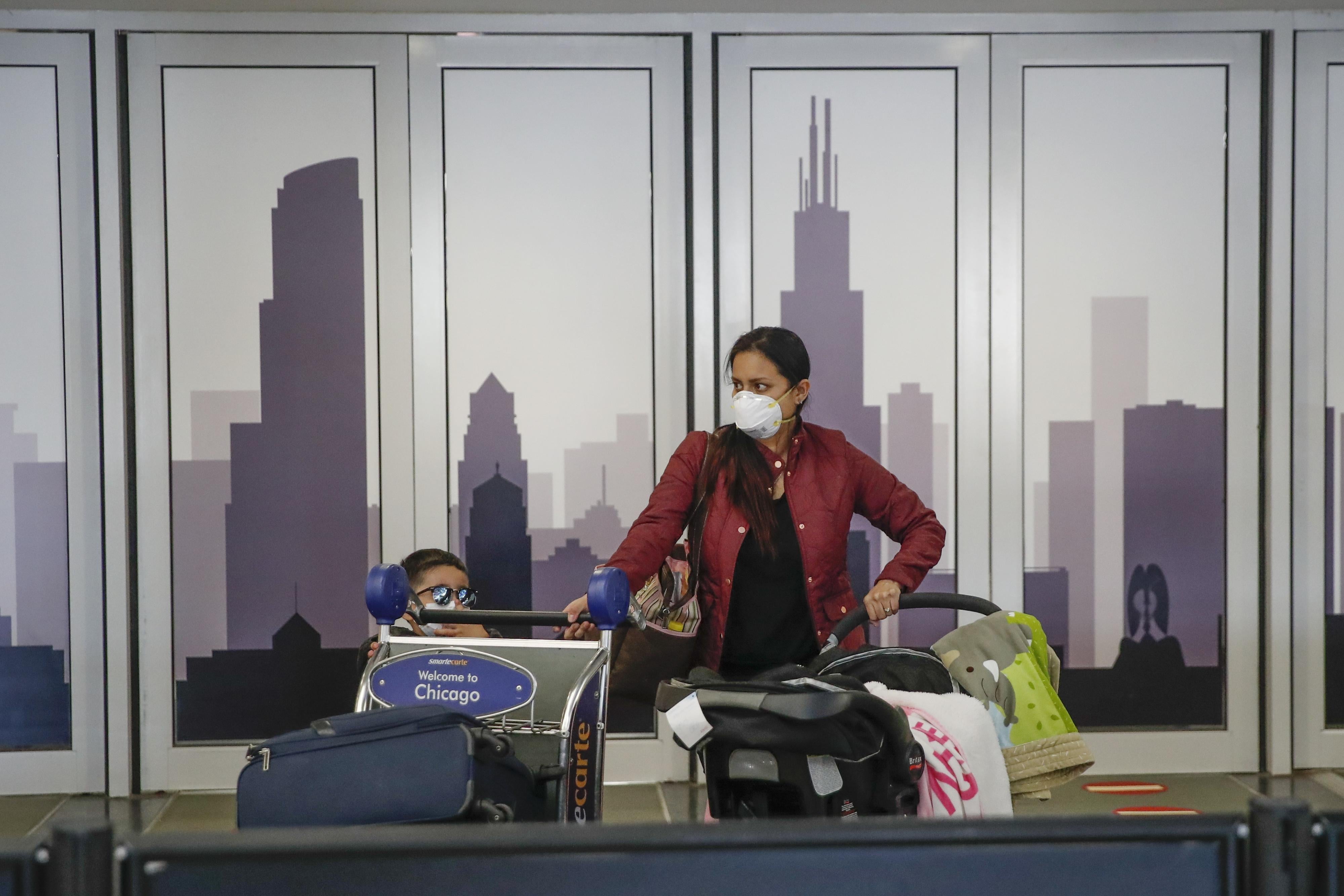 Travelers arrive at the international terminal of the O'Hare Airport in Chicago, Illinois, on March 13, 2020.