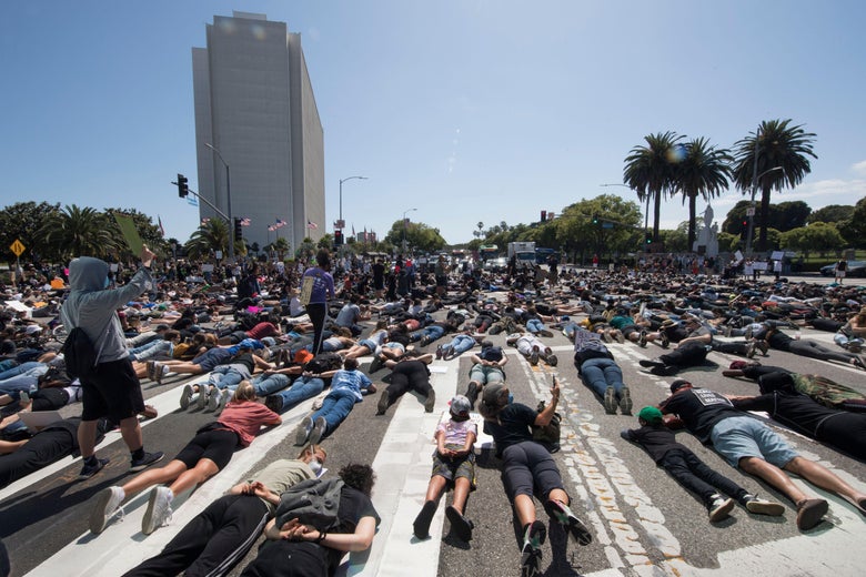 Protesters lie in the street as they block an intersection outside the Federal Building on busy Wilshire Blvd as they demonstrate against the death of George Floyd, in Westwood, California, on June 6, 2020.