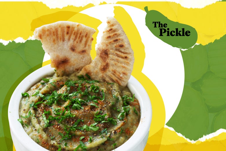 Eggplant dip in a white ceramic bowl with parsley and whole-grain flatbread.