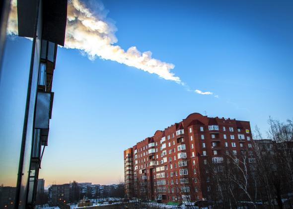 A meteorite trail is seen above a residential apartment block in Chelyabinsk, Russia, on Feb. 15, 2013. 